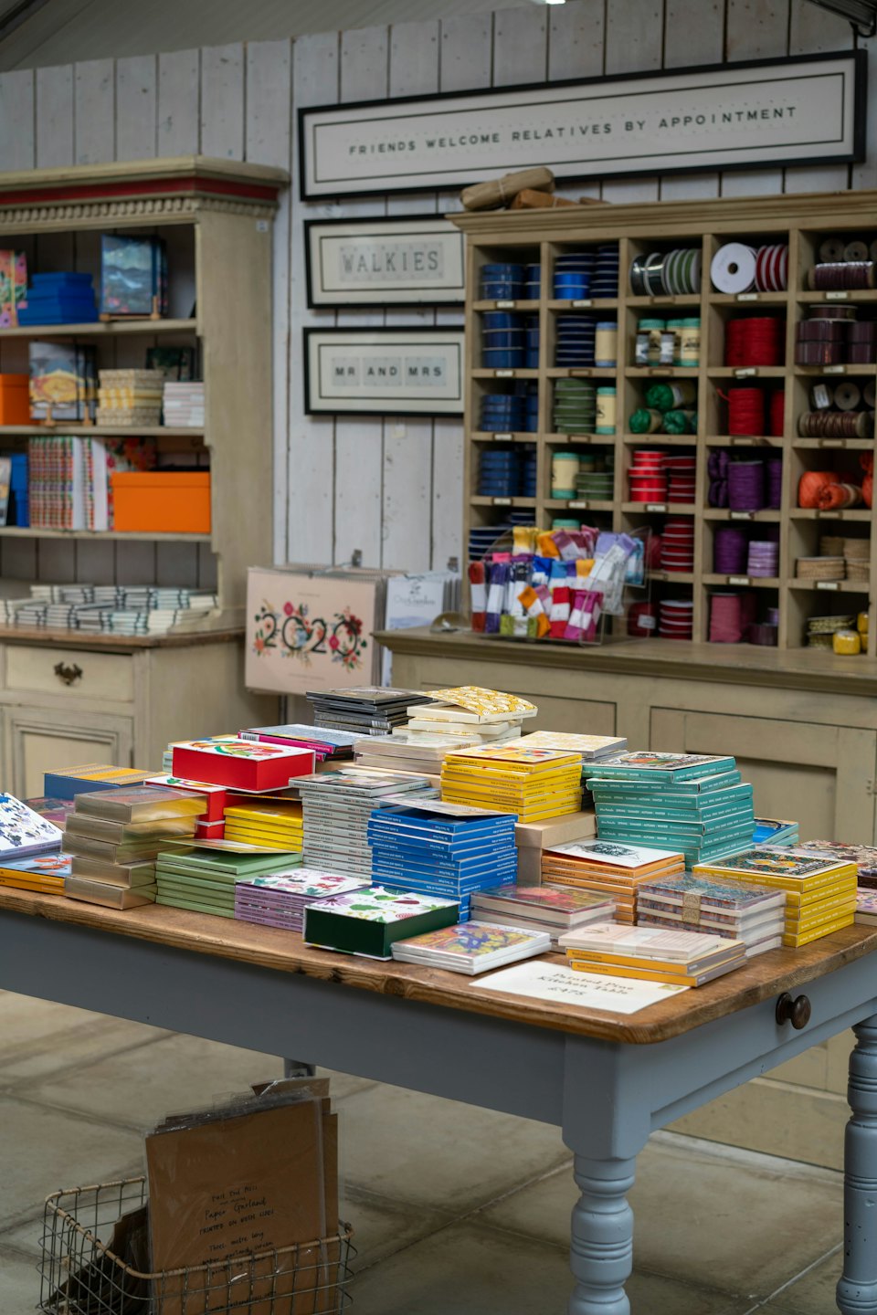 Stationery items arranged on a wooden table in a store.