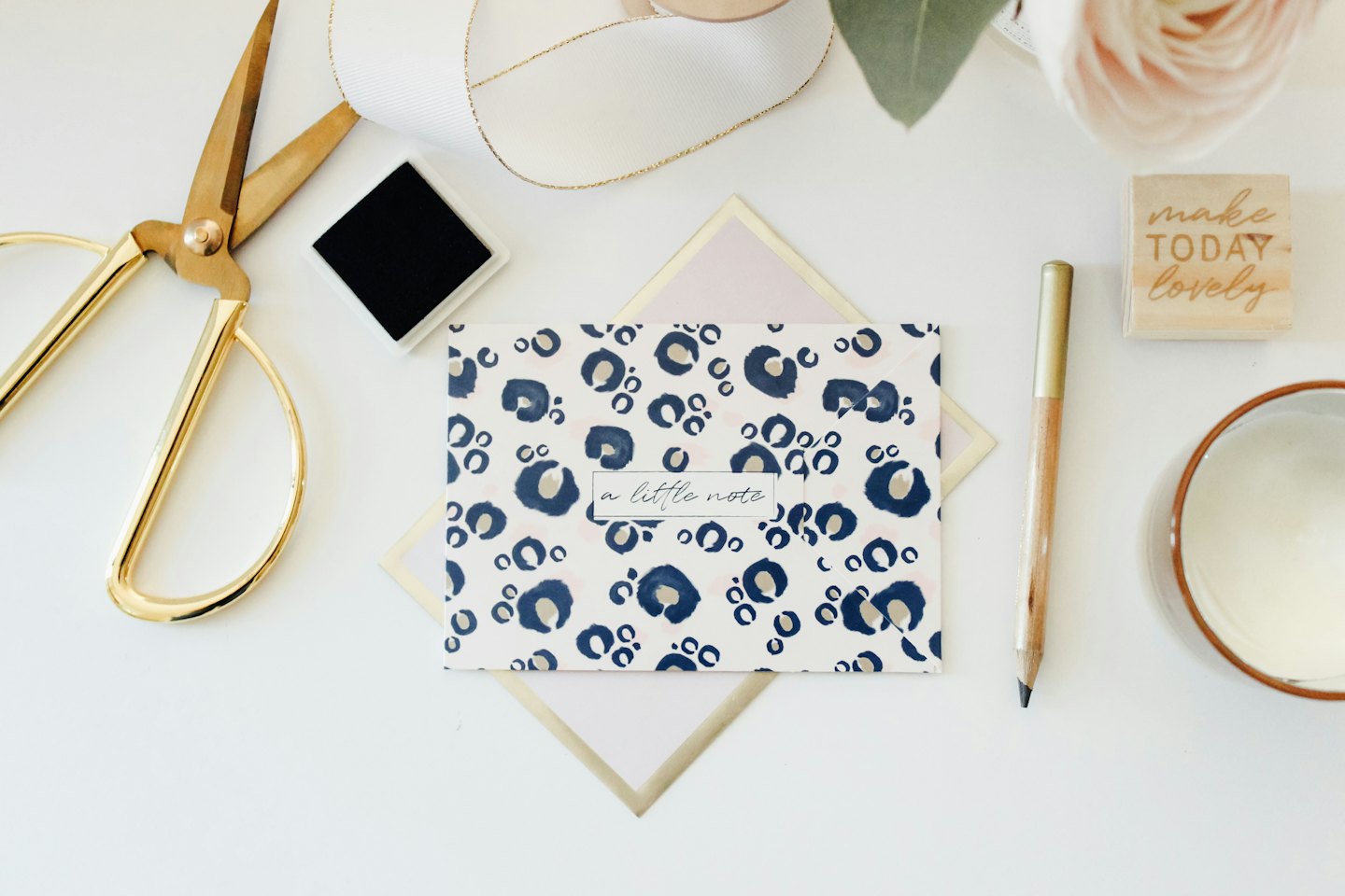 Stationery items arranged neatly on a clean white desk.