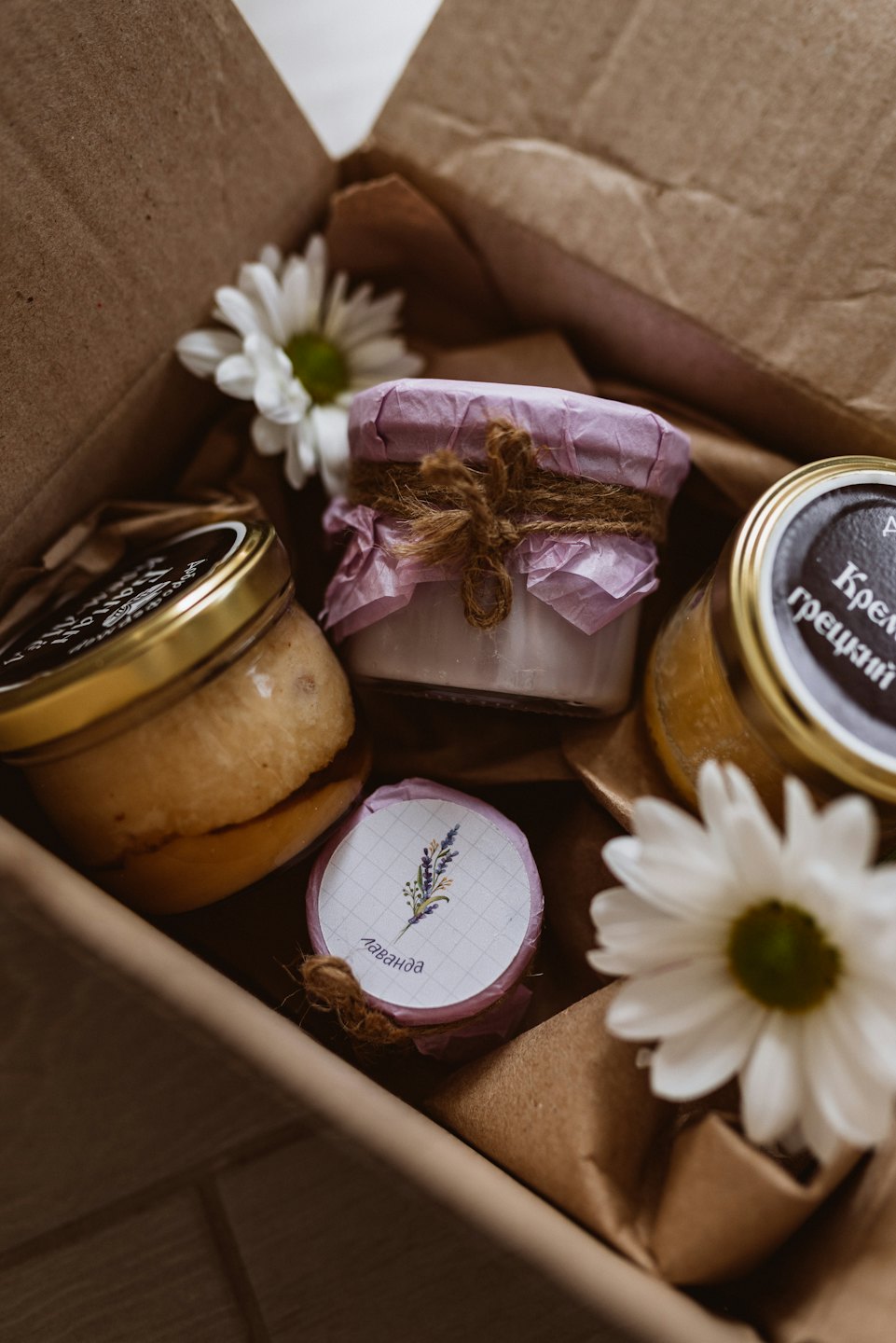 A gift box filled with honey, cream, and lavender items.